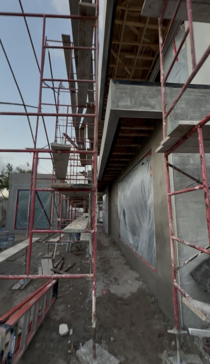 Construction site with scaffolding along the house