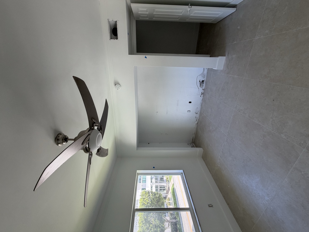 Bedroom with fresh paint, new tile floor and ceiling fan