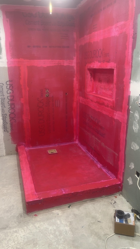 Shower waterproofed with red membrane before tile