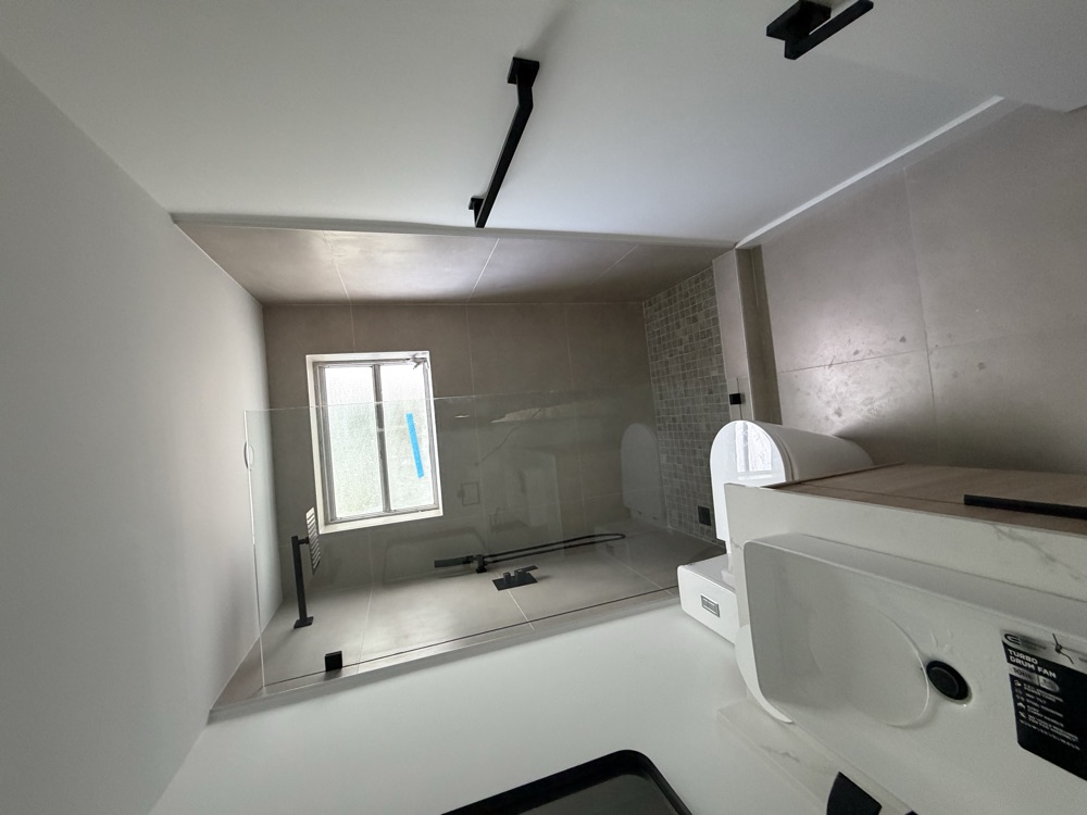 Finished shower with window and black fixtures