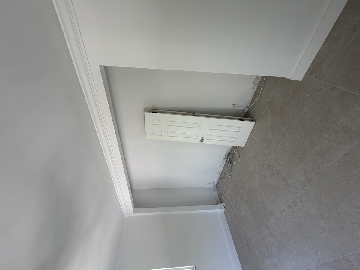After: finished opening with crown molding and fresh paint